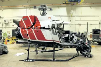  ?? TRANSPORTA­TION SAFETY BOARD PHOTO ?? The wreckage of a helicopter is shown at the Transporta­tion Safety Board of Canada's lab in Ottawa. The Transporta­tion Safety Board says evidence suggests a tool bag being carried outside a Hydro One helicopter struck the rear rotor of the aircraft...
