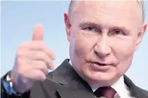  ?? AFP PHOTO ?? EASY VICTORY
Russia’s President Vladimir Putin raises his thumb during his meeting with the media at his campaign headquarte­rs in the capital Moscow on Monday, March 18, 2024.