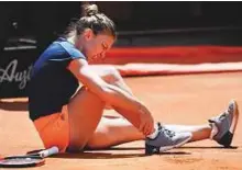  ?? AP ?? Simona Halep touches her ankle during her match against Elina Svitolina at the Italian Open finals last week.