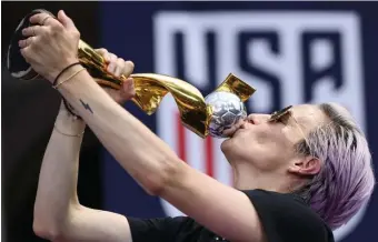  ?? GETTY IMAGES FILE ?? CUP CAPTAIN: Megan Rapinoe kisses the World Cup trophy in front of City Hall after the ticker tape parade for the U.S. women’s national soccer team in New York on July 10.