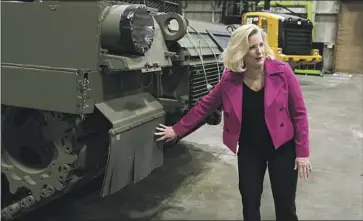  ?? Carlos Osorio Associated Press ?? U.S. ARMY Secretary Christine Wormuth shows an M1A2 Abrams battle tank as she tours a manufactur­ing plant in Lima, Ohio, last week. The plant may increase its production of 15 to 20 armored vehicles per month.