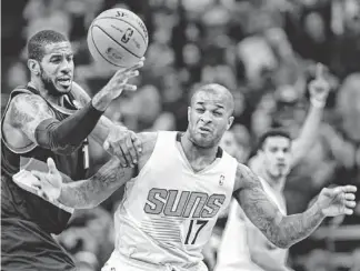  ??  ?? Suns small forward P.J. Tucker (17) fights for a loose ball with Trail Blazers power forward LaMarcus Aldridge in Wednesday’s game at US Airways Center.