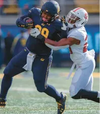  ?? JASON O. WATSON/GETTY ?? Cal fullback Malik McMorris, left, breaks a tackle from Stanford linebacker Bobby Okereke during a 2018 game. The ACC is looking into adding both schools.