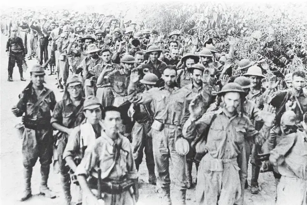  ?? ASSOCIATED PRESS FILE PHOTO ?? BELOW: On Aug. 12, 1942, American and Filipino troops are marched away to be placed in captivity after making their last stand against the Japanese during the fallout of the Battle of Bataan.