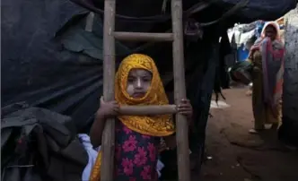  ?? MAHESH KUMAR A., THE ASSOCIATED PRESS ?? Rohingya Muslim girl Yasmin Ara stands in front of her shanty at a camp for refugees in Hyderabad, Monday.