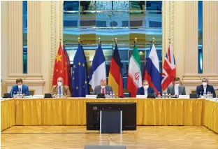  ?? (EU Delegation in Vienna/via Reuters) ?? EUROPEAN EXTERNAL Action Service (EEAS) Deputy Secretary General Enrique Mora and Iranian Deputy at the Ministry of Foreign Affairs, Abbas Araghchi, wait for the start of talks on reviving the 2015 Iran nuclear deal in Vienna last week.