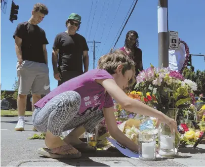  ?? AP PHOTOS ?? MEMORIAL: Coco Douglas, 8, stops at a memorial in Portland, Ore., for two bystanders who were stabbed to death while trying to stop a man police have identified as Jeremy Joseph Christian, left, who they say was yelling anti-Muslim slurs and acting...