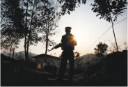  ?? Esther Htusan / Associated Press ?? A Kachin rebel stands guard at the armed group’s headquarte­rs in northern Kachin state, Myanmar.