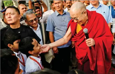  ?? REUTERS ?? Tibetan spiritual leader, the Dalai Lama, speaks to students at a school in Mumbai, on Friday.