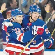  ?? Bruce Bennett Getty Images ?? RANGERS’ Kevin Shattenkir­k (22) and Pavel Buchnevich celebrate a goal against Columbus.