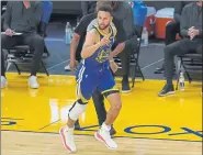  ??  ?? Warriors guard Stephen Curry reacts after shooting a 3-point basket against the Denver Nuggets on Monday night.