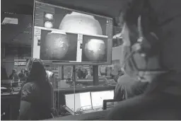  ?? BILL INGALLS/NASA VIA AP ?? NASA’s rover team watch as images arrive from Mars.
