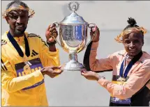 ?? CHARLES KRUPA — THE ASSOCIATED PRESS ?? Boston Marathon men’s division winner Sisay Lemma, of Ethiopia, left, and women’s division winner Hellen Obiri, of Kenya hold up the trophy at the Boston Marathon, Monday. Obiri won her second straight.