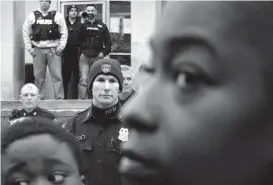  ?? Associated Press ?? n Members of the Baltimore Police Department stand guard April 23, 2015, outside the department’s Western District police station during a protest in response to Freddie Gray’s death in Baltimore. Baltimore’s mayor and commission­er say they are eager...