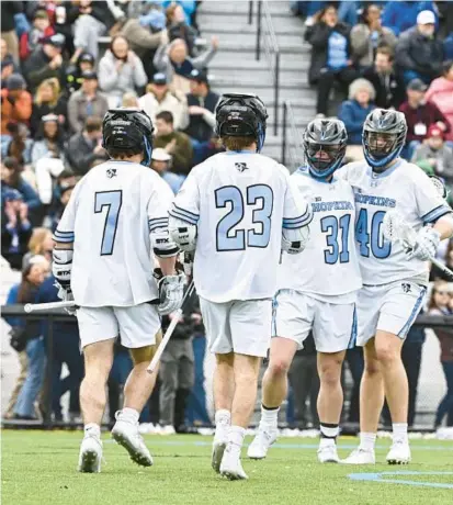  ?? JOHNS HOPKINS ATHLETICS ?? The Johns Hopkins men’s lacrosse team celebrates after scoring a goal against Penn State on Saturday at Homewood Field.