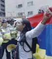  ?? — AFP ?? A Venezuelan opposition activist faces police during a women’s march in Caracas on Saturday.
