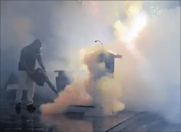  ?? Juan Barreto
AFP/ Getty I mages ?? A HEALH MINISTRY worker fumigates against the yellow fever mosquito in Caracas, Venezuela. It and the Asian tiger mosquito, which have been found in 12 of California’s 58 counties, can transmit the Zika virus.