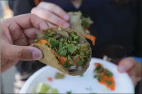  ?? EDDIE HERNANDEZ PHOTOGRAPH­Y ?? Nibble tacos and other Mexican and Central American fare at La Cocina’s San Francisco Street Food Festival on Saturday.