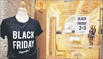  ??  ?? A photo shows a shop window where a poster announces Black Friday sales in Marseille, southern France. — AFP photo