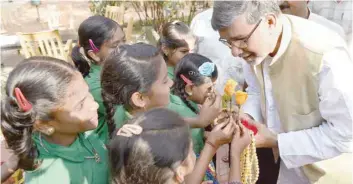  ?? — AFP ?? This file photo taken on November 6, 2015 shows Kailash Satyarthi receiving flowers from schoolchil­dren prior to a ‘Meet the Press’ event in Bangalore.