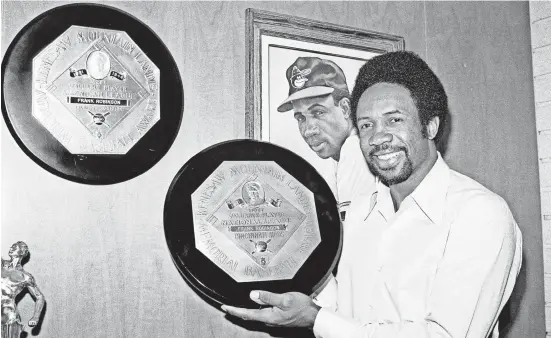  ?? AP FILE PHOTO BY HAROLD FILAN ?? At his home in Los Angeles in 1971, Frank Robinson displays the trophies he received for being the Most Valuable Player in both the American and National Leagues.