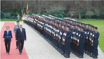  ?? — AFP ?? German President Frank-Walter Steinmeier and German Defence Minister Ursula von der Leyen review a guard of honour at the presidenti­al Bellevue palace in Berlin.