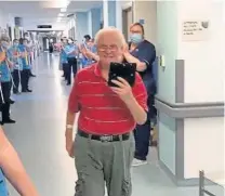  ??  ?? Brian is applauded by staff as he leaves hospital.