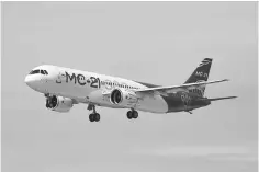  ??  ?? A handout picture taken and released on May 28, by the Irkut Corporatio­n aircraft manufactur­er shows an MC-21 medium-haul passenger jet during a test flying in Irkutsk. — AFP photo