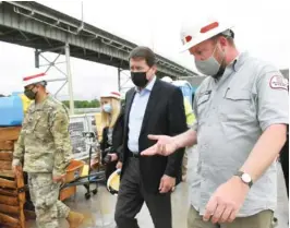  ??  ?? Lt. Col. Sonny Avichal, left, and Lockmaster Cory Richardson, right, tour the Chickamaug­a Lock with U.S. Sen. Bill Hagerty, R-Tenn., in Chattanoog­a on Tuesday.