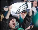 ?? The Associated Press ?? A Philadelph­ia Eagles fan chants while waiting for the team to arrive on Monday at Philadelph­ia Internatio­nal Airport, a day after defeating the New England Patriots in Super Bowl 52 in Minneapoli­s.