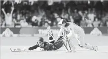  ?? AIJAZ RAHI THE ASSOCIATED PRESS ?? England’s Jos Buttler runs out New Zealand’s Martin Guptill in the Super Over in the Cricket World Cup final match at Lord’s cricket ground.