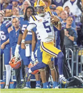  ?? STEPHEN LEW/USA TODAY SPORTS ?? LSU quarterbac­k Jayden Daniels rushes for a touchdown against Florida during the teams’ game last season in Baton Rouge, La. Daniels is expected to be among the first players selected in the NFL draft.