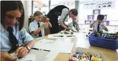  ?? Gulf News Archives ?? A student gets some help from a teacher during a sewing period in a classroom at Kings Dubai School in Umm Suqeim.