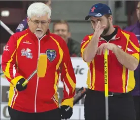  ?? The Canadian Press ?? Team Nunavut skip Jim Nix, left, and third Edmund MacDonald discuss their options during a Brier pre-qualifying curling match in St.John’s, N.L., on Friday.