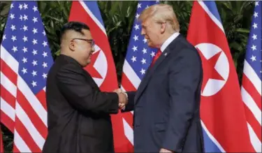  ?? EVAN VUCCI — THE ASSOCIATED PRESS FILE ?? President Donald Trump shakes hands with North Korea leader Kim Jong Un at the Capella resort on Sentosa Island in Singapore.