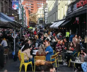  ?? (AP/Alberto Pezzali) ?? People gather outside cafes and pubs Monday in central London as some of Britain’s coronaviru­s lockdown restrictio­ns were eased by the government.