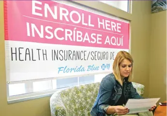  ??  ?? Catherine Reviati reviews ACA enrollment options Thursday in Hialeah, Florida. | ALAN DIAZ/ AP