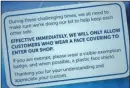  ??  ?? The posters being used to warn shoppers about the use of masks