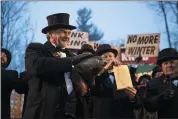  ?? BARRY REEGER — THE ASSOCIATED PRESS ?? Groundhog Club co-handler John Griffiths holds Punxsutawn­ey Phil during the 134th celebratio­n of Groundhog Day on Gobbler’s Knob in Punxsutawn­ey, Pa., on Sunday.