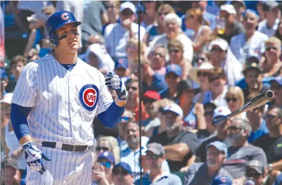  ??  ?? Cubs star Anthony Rizzo tosses his bat aside after being called out on strikes to end the third inning during a game Saturday against the Rockies at Wrigley Field. | NAM Y. HUH/ AP