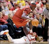  ?? AP/CHARLIE NEIBERGALL ?? Arkansas forward Bobby Portis (10) tries to get away from Iowa State’s Monte Morris after gaining control of a loose ball in the Cyclones’ 95-77 victory Thursday in Ames, Iowa.