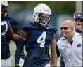  ?? ABBY DREY — THE ASSOCIATED PRESS ?? Penn State football coach James Franklin, second from front right, congratula­tes freshman cornerback Kalen King (4) after winning a 1-on-1 against a wide receiver during an NCAA college football practice in State College, Pa.,