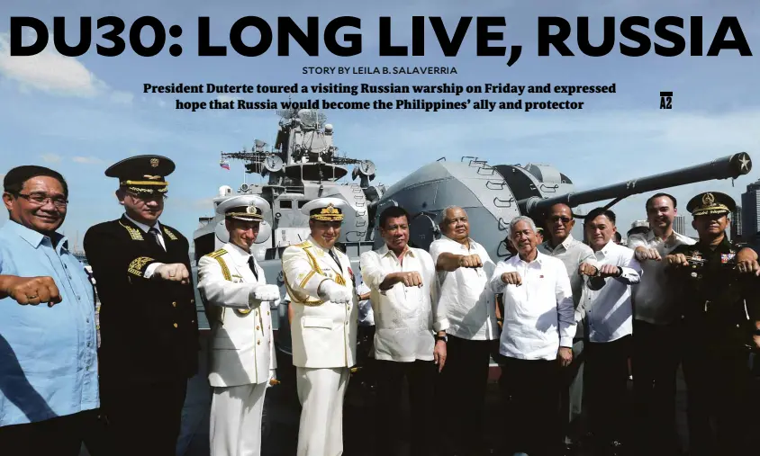  ??  ?? GOODWILLVI­SIT President Duterte flashes his signature clenched-fist sign with Russian Navy officials and members of his Cabinet after touring the visiting Russian ship Admiral Tributs on Friday.