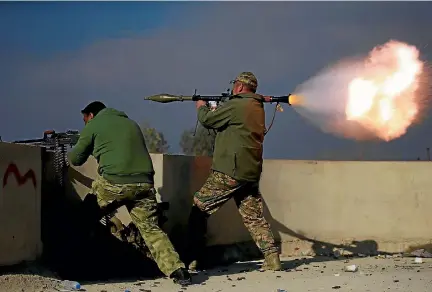  ?? PHOTO: REUTERS ?? A member of Iraqi rapid response forces fires a rocket launcher during a battle with Islamic State militants in the district of Yarimja in southern Mosul.