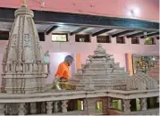  ?? (AFP) ?? An Indian worker walks past a model of a proposed temple in Ayodhya on Monday
