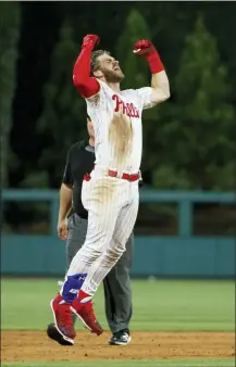  ?? MATT SLOCUM -AP ?? The Philadelph­ia Phillies’ Bryce Harper celebrates after hitting a gamewinnin­g tworun double off Los Angeles Dodgers relief pitcher Kenley Jansen during the ninth inning of a baseball game Tuesday, in Philadelph­ia. Philadelph­ia won 9-8.