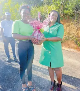  ?? ?? Member of Parliament Kerensia Morrison being present with a token by Semoya Taylor on March 23, 2024 at the opening of the Caledonia Road.
