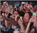  ??  ?? Snap-happy: Fans at a concert