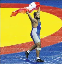  ?? CAMERON SPENCER/ GETTY IMAGES FILE ?? Arjan Bhullar celebrates winning the 120-kg freestyle wrestling gold medal at the 2010 Commonweal­th Games.