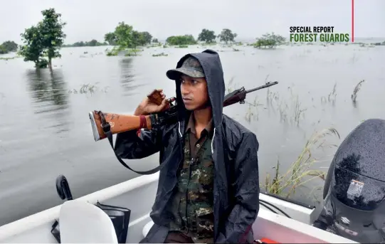  ??  ?? KEEPING AN EYE OUT
Forest guards patrolling the floodwater­s of the Kaziranga national park